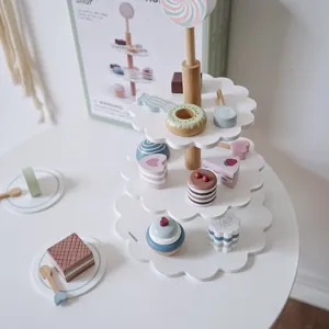Detailed close-up view of wooden tiered dessert stand toy set with cute colorful sweet pastries.