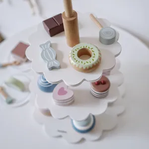 Close-up detail of wooden afternoon tea dessert toy set, featuring tiered stand and sweet treats.