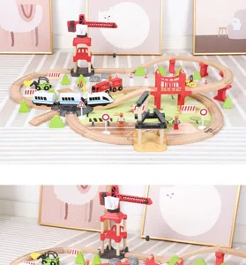 Wooden railway toy set detail view with electric train, crane, tracks and bridge accessories.