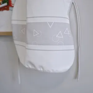 Detailed shot of white canvas fabric item featuring stylish grey stripes and geometric patterns.