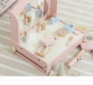 Detailed view of wooden pretend play makeup vanity set, featuring miniature wooden toys and accessories.
