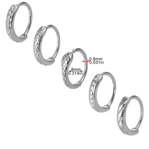 Detailed view of geometric copper alloy nose ring, highlighting 8mm size and fine textured pattern.