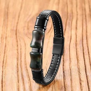 Close-up of black leather bracelet with retro stone bamboo beads and magnetic clasp detail.