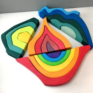 Wooden stacking rainbow toy detail showing colorful arches, flame and mountain shapes for kids learning.