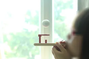 Wooden suspension blowing ball toy detail showing interactive sensory training gameplay.