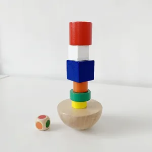 Wooden balancing toy detail showing colorful stacked blocks, hemisphere base and dice.