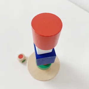 Wooden educational balancing toy detail, colorful stacking blocks and round wooden base.