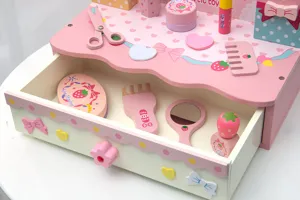 Wooden pretend play makeup vanity toy set with drawer and cute pink accessories for kids.