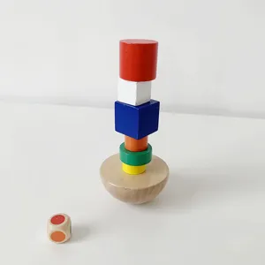 Wooden balancing toy set detail showing colorful stacking blocks on a hemisphere base with a dice.