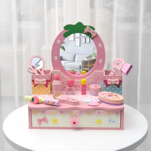 Wooden kids pretend play vanity toy detail view showing cute pink makeup table and cute accessories.