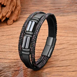 Close up view of multi-layer leather bracelet detail, showing braided texture and metal clasp.