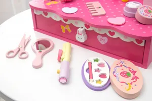 Wooden pretend play makeup vanity toy detail shot, pink wooden accessories and cute tools.