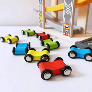 Wooden ramp racer toy detail showing colorful sliding cars on a wooden track closeup.