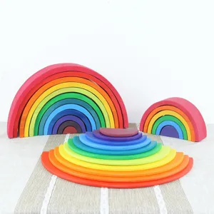 Detailed view of large wooden rainbow stacking blocks set, 12 colorful arch and semicircle pieces.