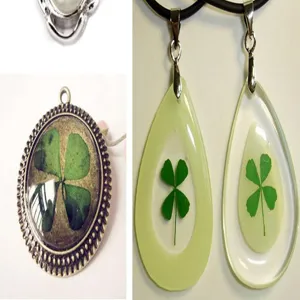 Close-up details of handmade four leaf clover resin epoxy and glass dome pendant necklaces.