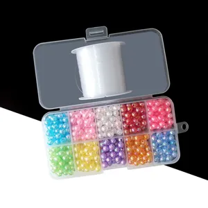 Acrylic bead and elastic string DIY material kit detail showing colorful loose beads in box.