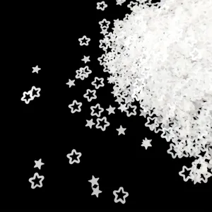 Macro detail of translucent matte frosted star sequins for nail art and DIY craft design.