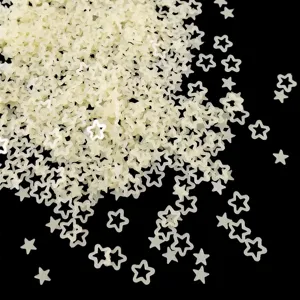 Close-up detail of translucent matte hollow star flower sequin nail art DIY craft pieces.