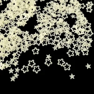 Close-up of translucent hollow star sequins, frosted nail art DIY materials detail view.