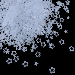 Close-up of translucent matte hollow star and flower sequins for resin nail art DIY decor.