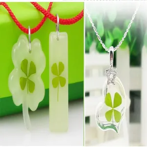 Four leaf clover dried flower necklace handmade resin crystal pendant lucky jewelry detail.