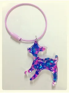DIY epoxy resin glitter deer pendant detail shot, transparent handmade accessory showcasing.