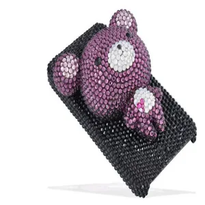 Handmade rhinestone phone case with a cute purple bear design, sparkling crystal accessory detail.