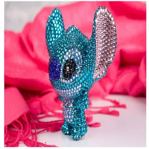 Detailed close-up view of sparkling rhinestone crystal cartoon character figurine charm.