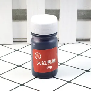 Detail shot of 10g red epoxy resin pigment dye bottle for crystal glue and resin crafts close up.