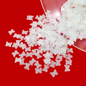 Detailed shot of matte white hollow butterfly sequins for DIY craft, nail art and resin filling.