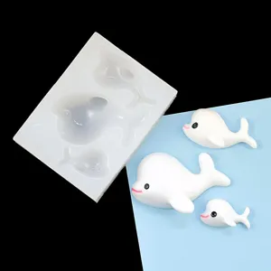 Detailed view of silicone dolphin mold and cute finished resin animal figurines for DIY crafts.