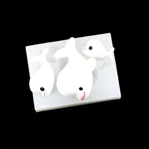 Close-up details of ocean dolphin silicone mold and handmade resin craft pieces display.