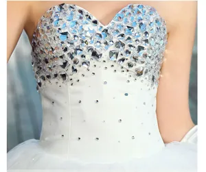 Close-up view of wedding dress rhinestone embellishments, sparkling acrylic crystals detail.