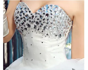 Stunning rhinestone embellished white corset bodice wedding dress detail closeup sparkling crystals.