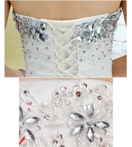 Hand-sewn rhinestone wedding dress detail shot, featuring sparkling acrylic flatback gems and lace.