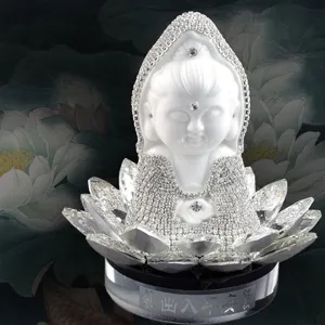 Detailed view of white ceramic rhinestone Guanyin Buddha figurine with crystal lotus base.