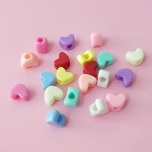 Colorful heart-shaped loose beads with large holes for DIY handmade bracelets and necklaces crafting.