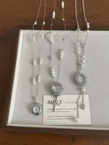 Punk style metal watch pendant necklace with pearls and delicate chain details for women.
