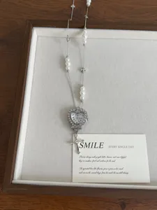 Sweet cool style metal watch pendant necklace with pearls and cross charms for women.