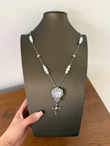 Detail view of the sweet-cool style heart watch pendant necklace with pearl beaded chain.