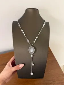 Sweet-cool style metal watch pendant necklace with pearls and cross elements, detailed view.
