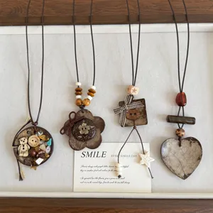 Detailed view of retro coconut shell cat necklace, ethnic wooden beaded sweater chain.