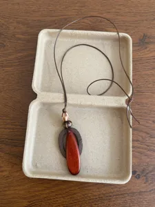 Detailed view of retro wooden beaded sweater chain necklace, ethnic style pendant detail.