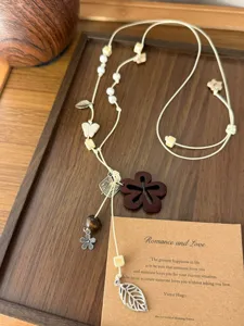 Retro ethnic style wooden beaded necklace with floral charms and adjustable cord for women.