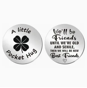 Stainless steel pocket hug token detail showing engraved friendship quote and clover.