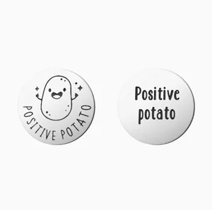 Stainless steel positive potato pocket coin detail view, engraved motivational round token.