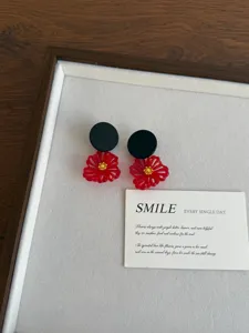 Retro style red flower cluster stud earrings with black disc design, elegant fashion jewelry.