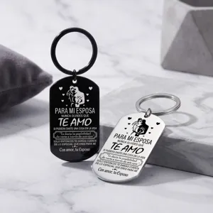 Detailed view of stainless steel couple keychains featuring engraved Spanish love quotes.
