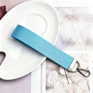 Light blue fabric wristlet keychain strap with silver metal clasp for keys bags charm
