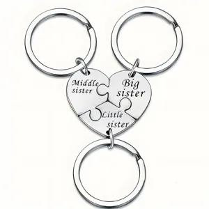 Stainless steel puzzle heart keychain close-up, sister engraved detail, metal ring pendant.